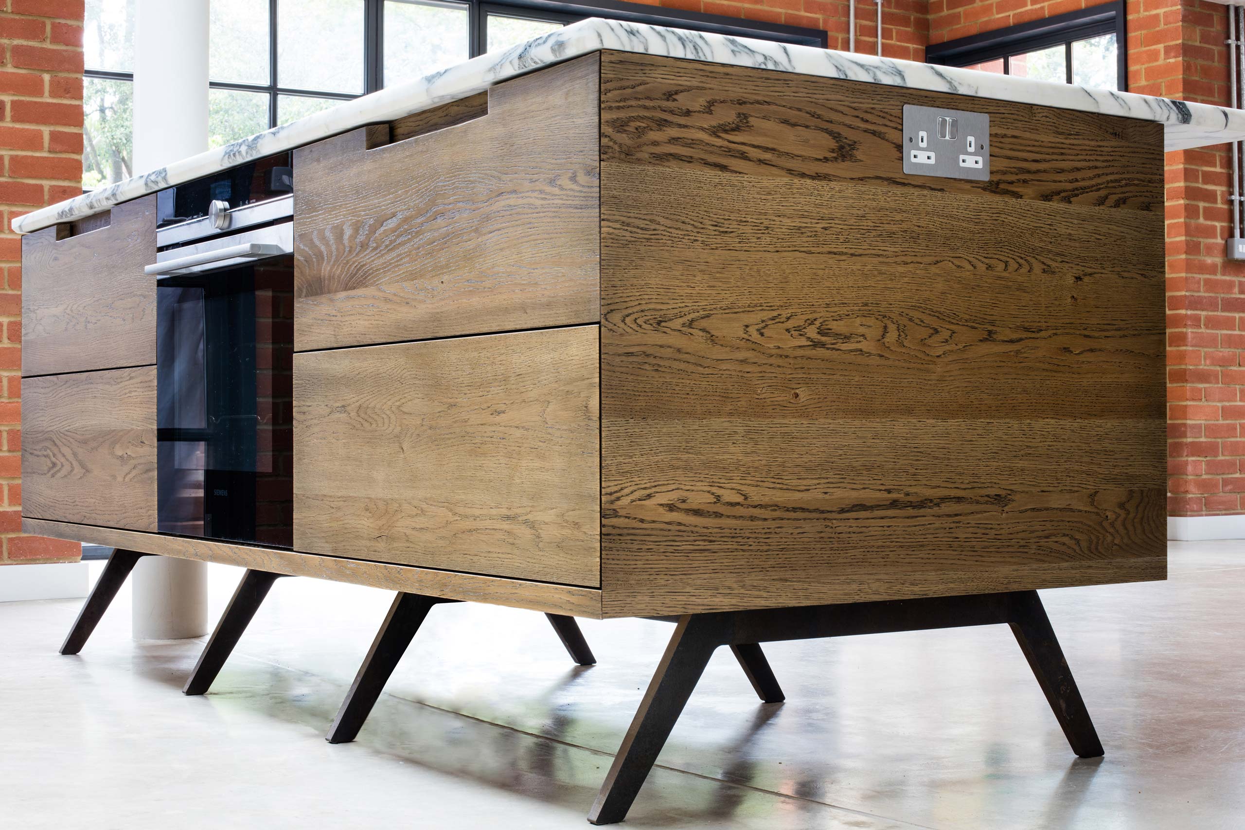 Fumed oak island unit with marble top and metal legs by Six Hands