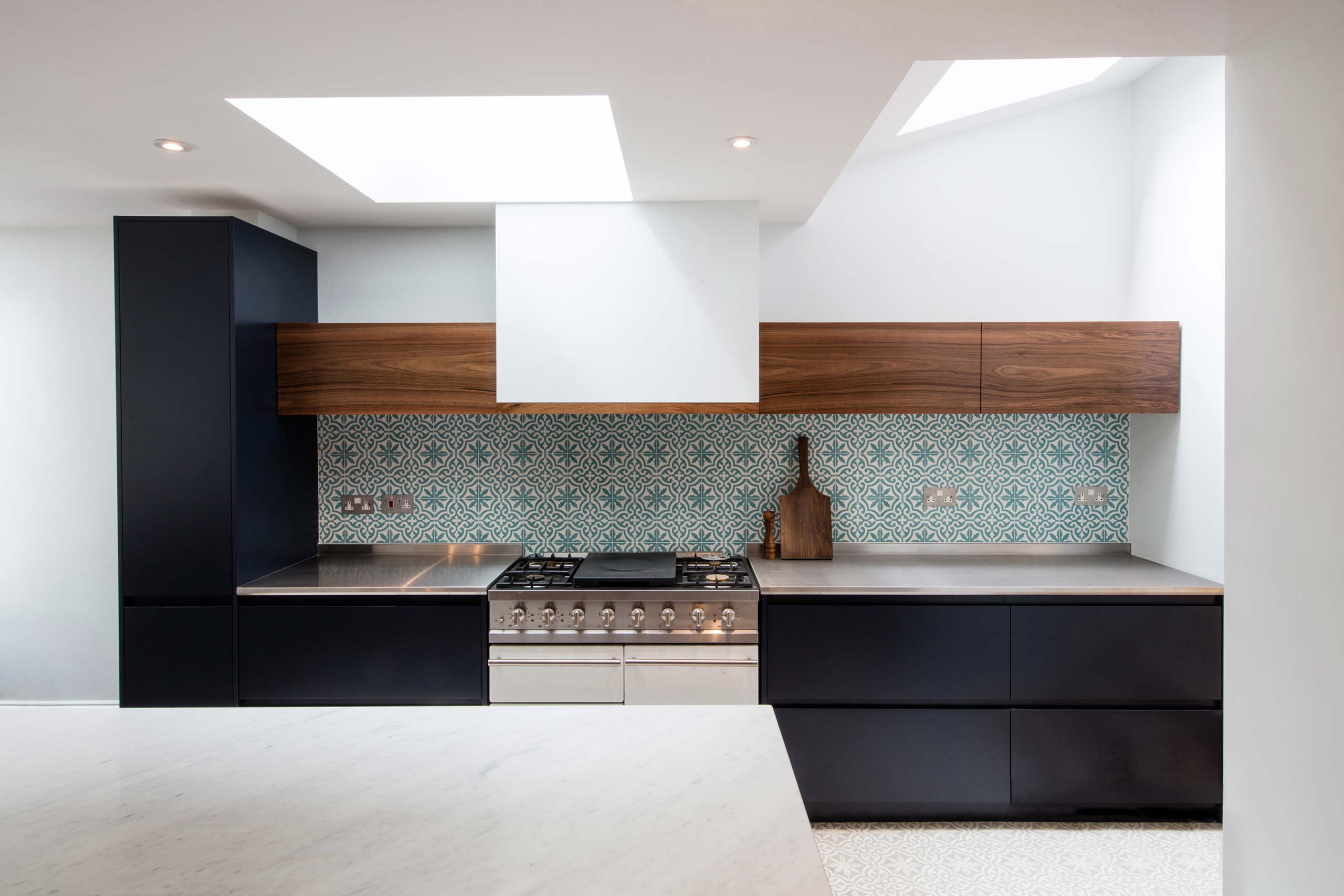 Bespoke handmade kitchen in navy blue, English walnut, marble and stainless steel by Six Hands